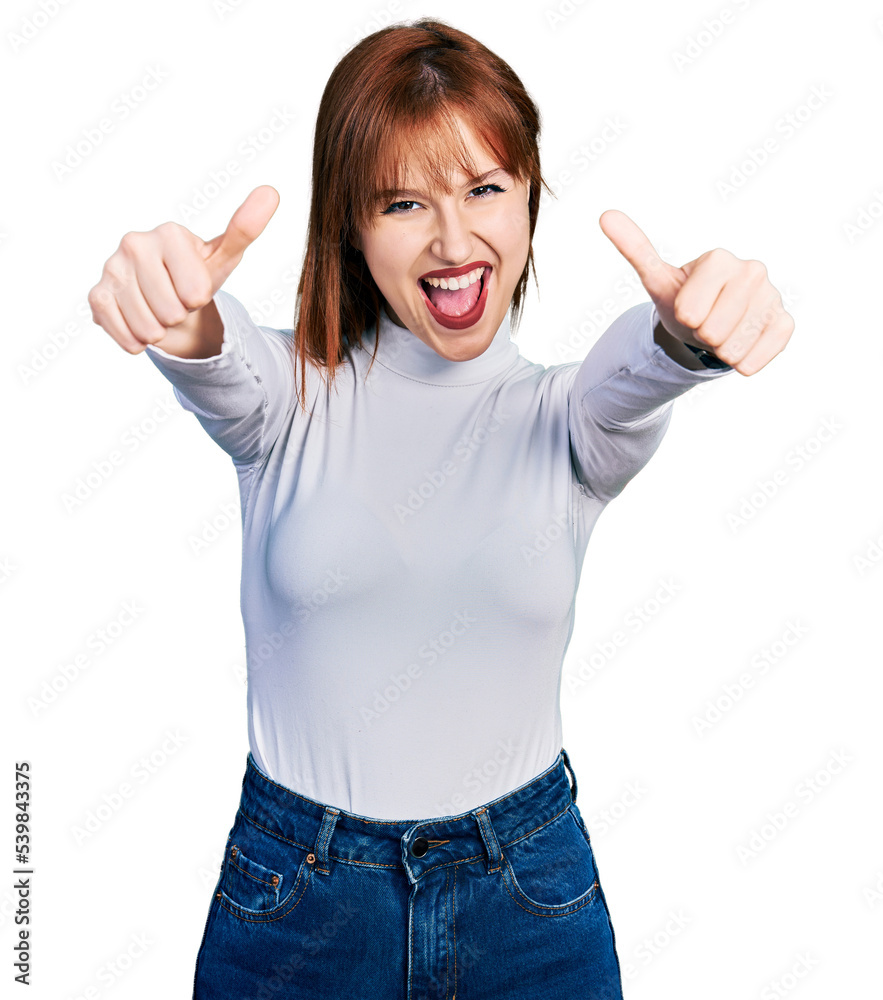 Redhead young woman wearing casual turtleneck sweater approving doing positive gesture with hand, thumbs up smiling and happy for success. winner gesture. Redhead young woman wearing casual turtleneck sweater approving doing positive gesture with hand, thumbs up smiling and happy for success. winner gesture.