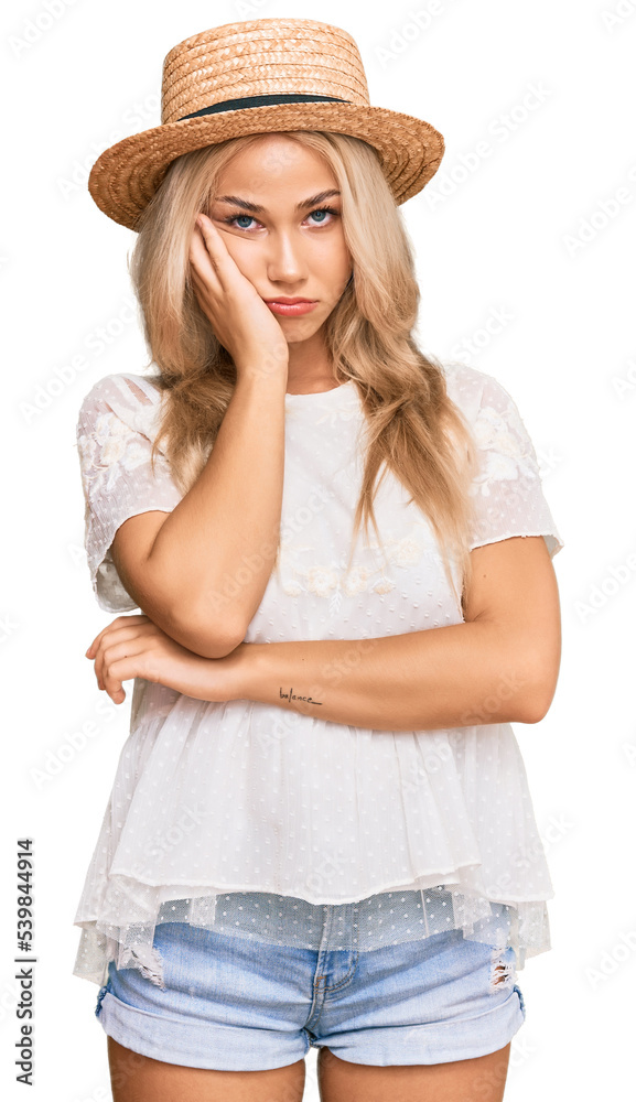 Young blonde girl wearing summer hat thinking looking tired and bored with depression problems with crossed arms. Young blonde girl wearing summer hat thinking looking tired and bored with depression problems with crossed arms.