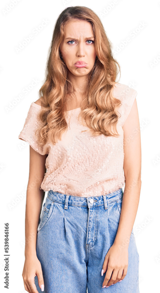 Fototapeta premium Young beautiful caucasian woman with blond hair wearing casual clothes depressed and worry for distress, crying angry and afraid. sad expression.