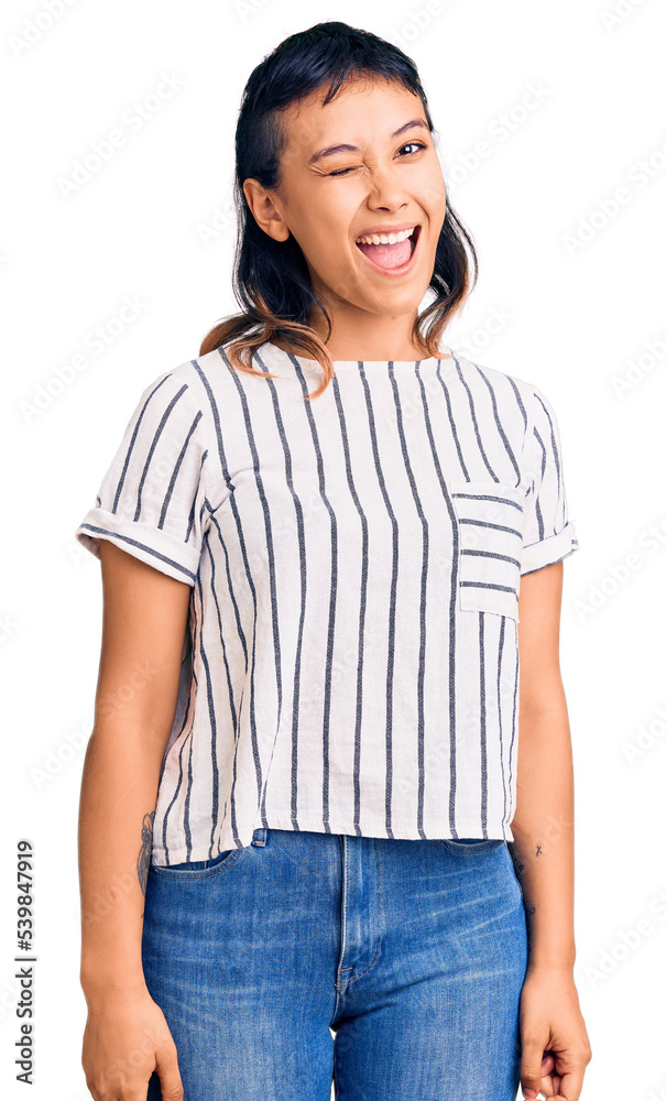 Young woman wearing casual clothes winking looking at the camera with sexy expression, cheerful and happy face. Young woman wearing casual clothes winking looking at the camera with sexy expression, cheerful and happy face.