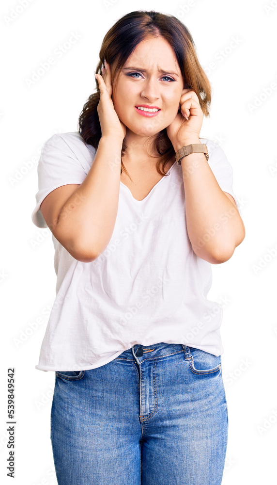 Young beautiful caucasian woman wearing casual white tshirt covering ears with fingers with annoyed expression for the noise of loud music. deaf concept. Young beautiful caucasian woman wearing casual white tshirt covering ears with fingers with annoyed expression for the noise of loud music. deaf concept.