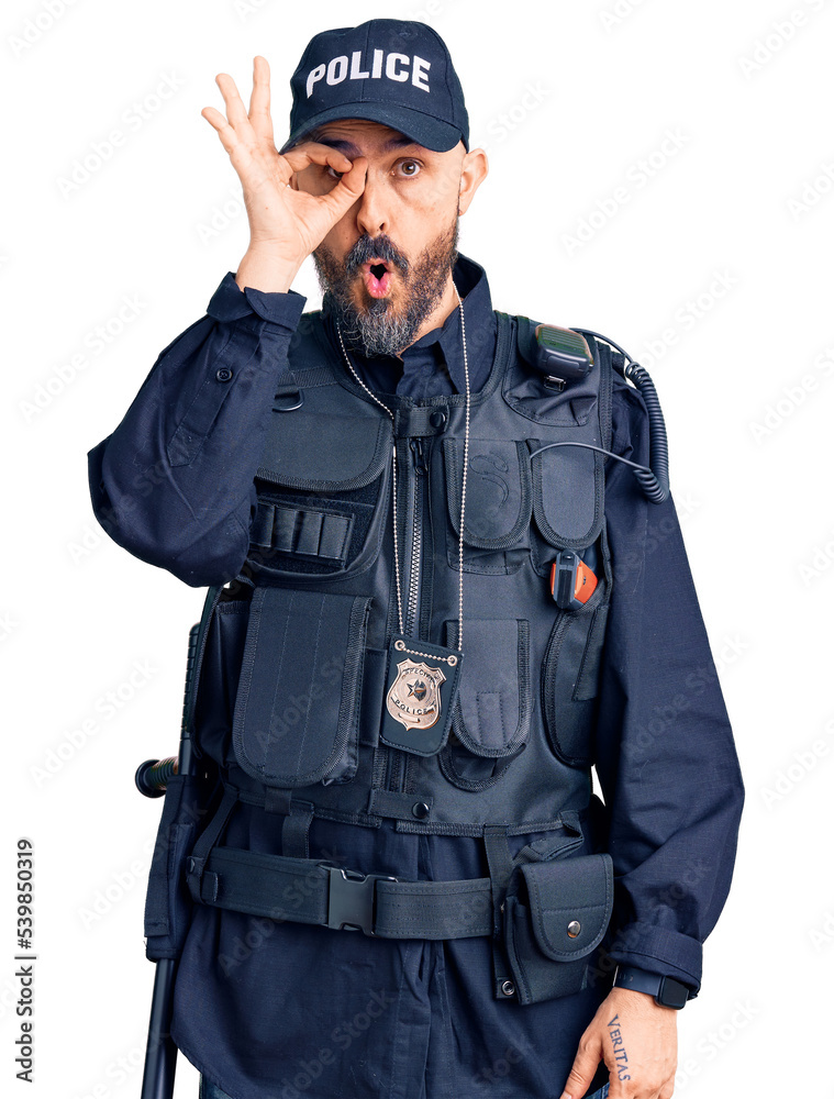Young handsome man wearing police uniform doing ok gesture shocked with surprised face, eye looking through fingers. unbelieving expression. Young handsome man wearing police uniform doing ok gesture shocked with surprised face, eye looking through fingers. unbelieving expression.