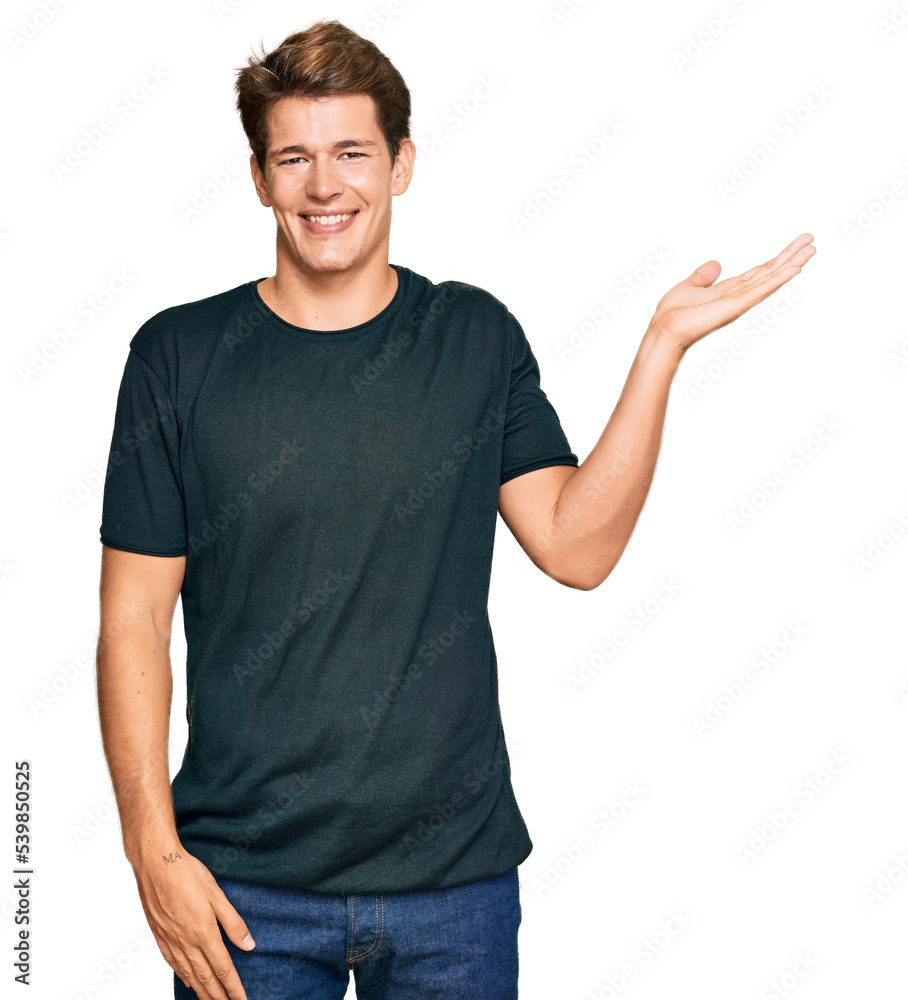 Handsome caucasian man wearing casual clothes smiling cheerful presenting and pointing with palm of hand looking at the camera. Handsome caucasian man wearing casual clothes smiling cheerful presenting and pointing with palm of hand looking at the camera.