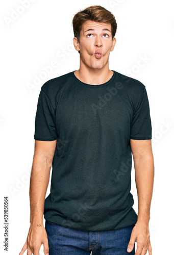 Handsome caucasian man wearing casual clothes making fish face with lips, crazy and comical gesture. funny expression. © Krakenimages.com