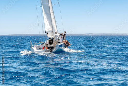 Sailing crew on sailboat during yacht regatta
