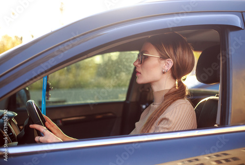 Young confident business lady in glasses in car, active independent woman lifestyle © okostia