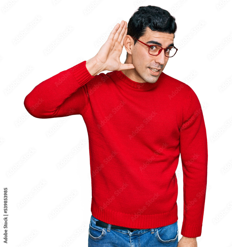 Handsome hispanic man wearing casual clothes and glasses smiling with hand over ear listening an hearing to rumor or gossip. deafness concept. Handsome hispanic man wearing casual clothes and glasses smiling with hand over ear listening an hearing to rumor or gossip. deafness concept.