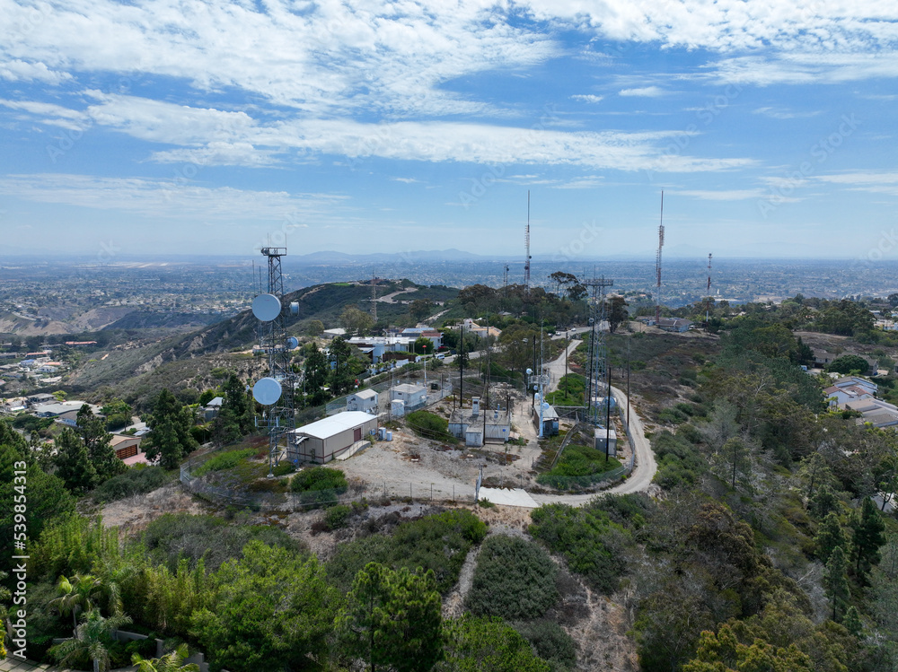 Aerial view of telecommunication tower with 5G cellular network antenna on the top of a valley in San Diego, South California