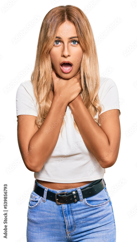 Beautiful blonde young woman wearing casual white tshirt shouting and suffocate because painful strangle. health problem. asphyxiate and suicide concept. Beautiful blonde young woman wearing casual white tshirt shouting and suffocate because painful strangle. health problem. asphyxiate and suicide concept.