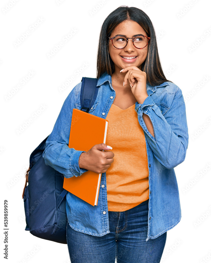Young latin girl wearing student backpack and holding books with hand on chin thinking about question, pensive expression. smiling and thoughtful face. doubt concept. - obrazy, fototapety, plakaty 