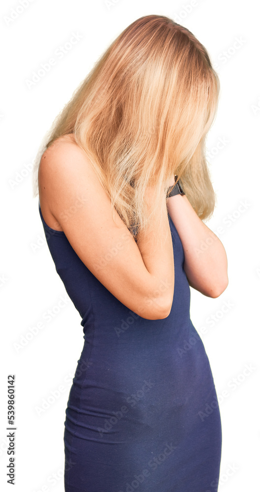 Young beautiful blonde woman wearing casual dress with sad expression covering face with hands while crying. depression concept. Young beautiful blonde woman wearing casual dress with sad expression covering face with hands while crying. depression concept.