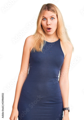 Young beautiful blonde woman wearing casual dress afraid and shocked with surprise expression, fear and excited face. © Krakenimages.com
