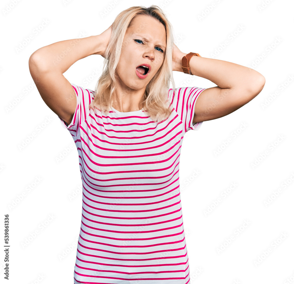 Young caucasian woman wearing casual clothes crazy and scared with hands on head, afraid and surprised of shock with open mouth Young caucasian woman wearing casual clothes crazy and scared with hands on head, afraid and surprised of shock with open mouth