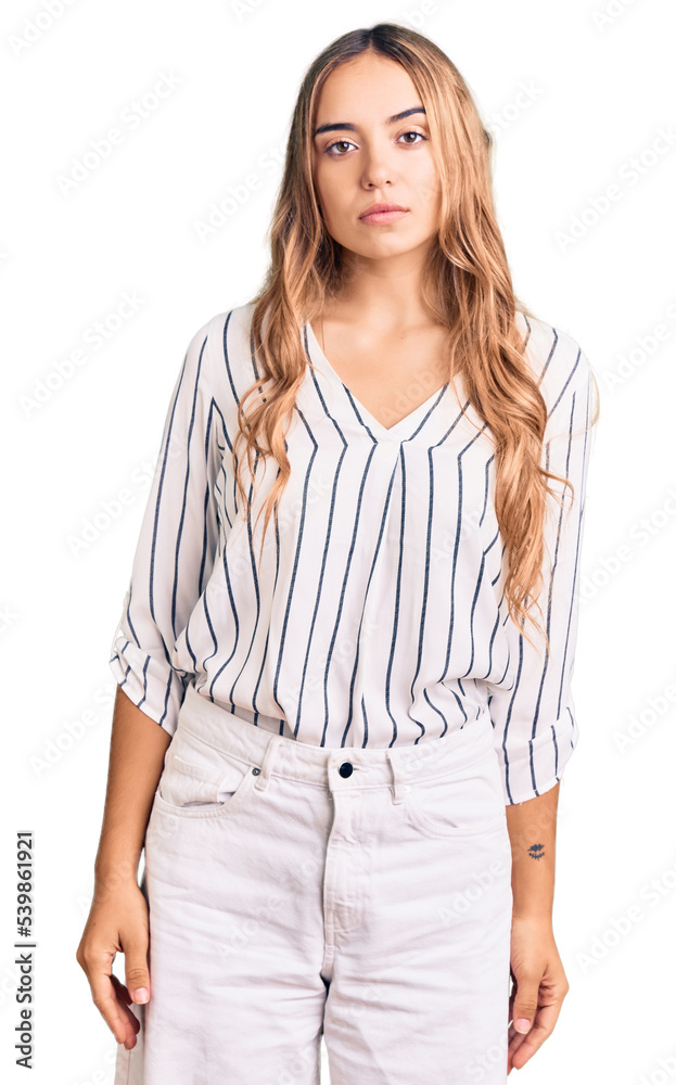 Young beautiful blonde woman wearing casual clothes with serious expression on face. simple and natural looking at the camera. Young beautiful blonde woman wearing casual clothes with serious expression on face. simple and natural looking at the camera.