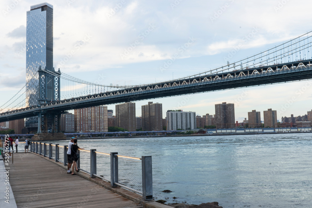 Empire Fulton Ferry promenade area in Brooklyn Bridge Park. Located between the historic Manhattan and Brooklyn Bridges. Seen here is the Manhattan Bridge. 
