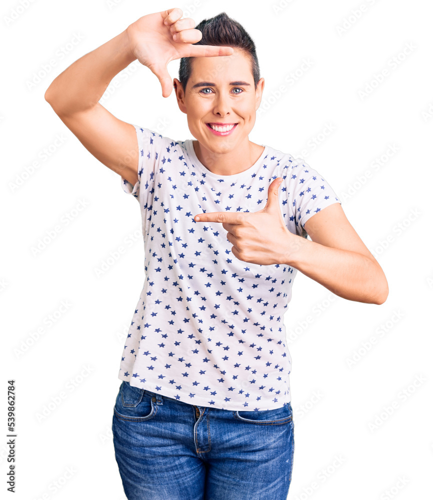 Young woman with short hair wearing casual clothes smiling making frame with hands and fingers with happy face. creativity and photography concept. Young woman with short hair wearing casual clothes smiling making frame with hands and fingers with happy face. creativity and photography concept.