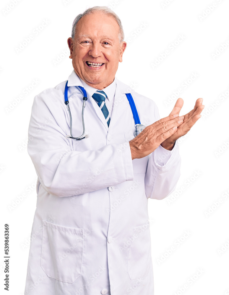 Senior handsome grey-haired man wearing doctor coat and stethoscope clapping and applauding happy and joyful, smiling proud hands together Senior handsome grey-haired man wearing doctor coat and stethoscope clapping and applauding happy and joyful, smiling proud hands together