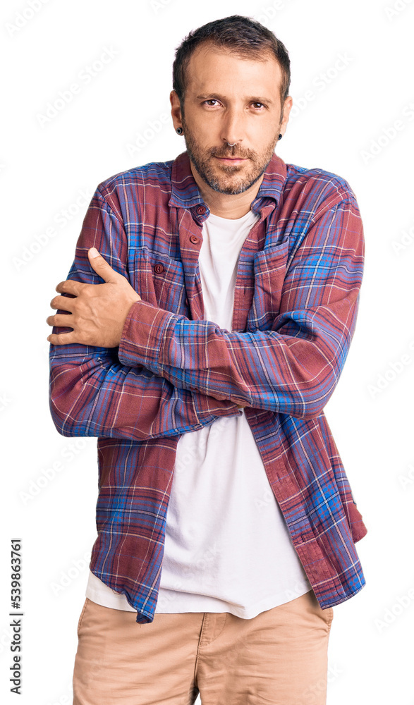 Young handsome man wearing casual clothes shaking and freezing for winter cold with sad and shock expression on face Young handsome man wearing casual clothes shaking and freezing for winter cold with sad and shock expression on face