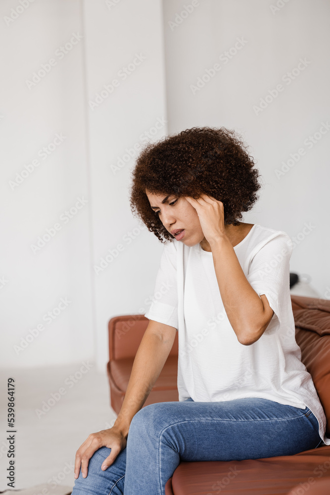 Migraine is a strong headache of african american woman. Overstressed woman touches her head because of pain. Depression of attractive girl. Migraine is a strong headache of african american woman. Overstressed woman touches her head because of pain. Depression of attractive girl.