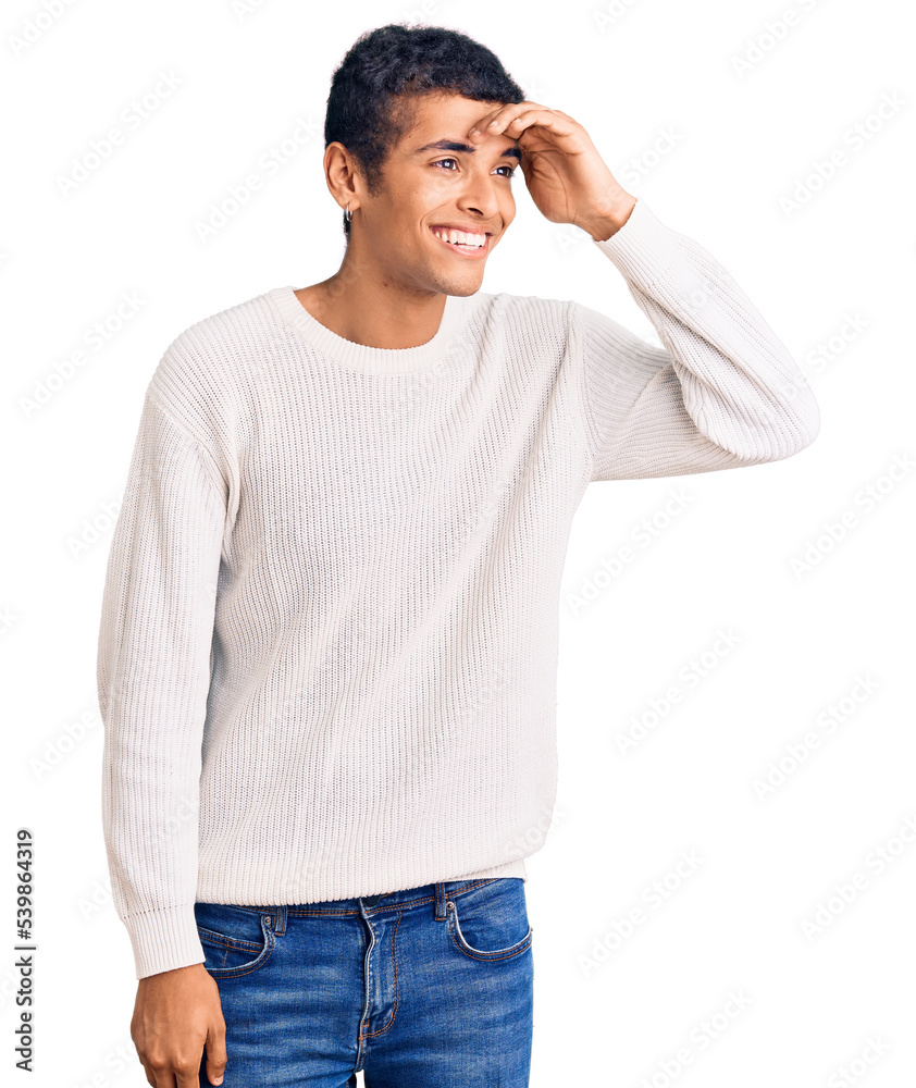 Young african amercian man wearing casual clothes very happy and smiling looking far away with hand over head. searching concept. Young african amercian man wearing casual clothes very happy and smiling looking far away with hand over head. searching concept.