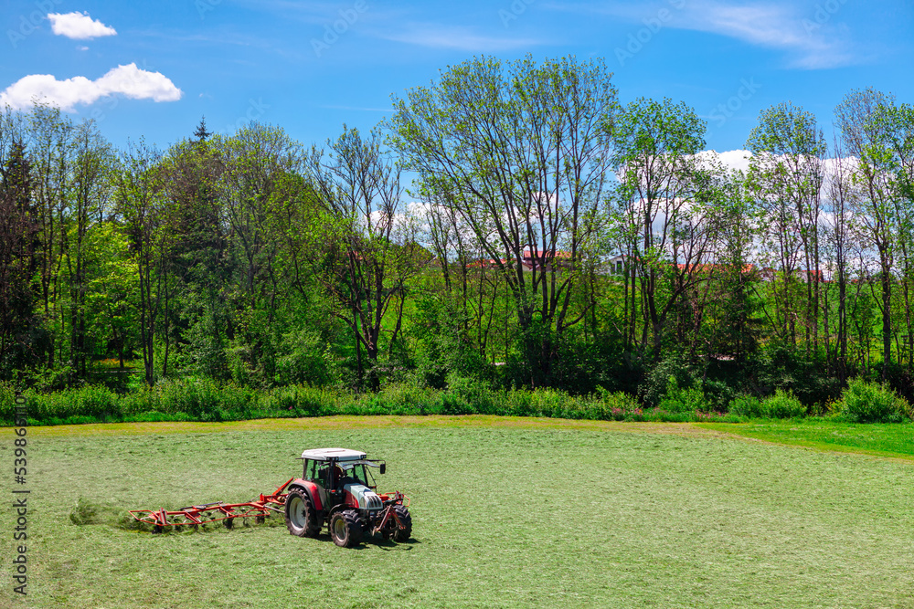 Tractor on agricultural land . Agricultural machine on springtime field