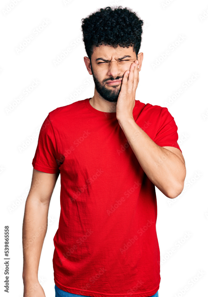 Young arab man with beard wearing casual red t shirt touching mouth with hand with painful expression because of toothache or dental illness on teeth. dentist Young arab man with beard wearing casual red t shirt touching mouth with hand with painful expression because of toothache or dental illness on teeth. dentist