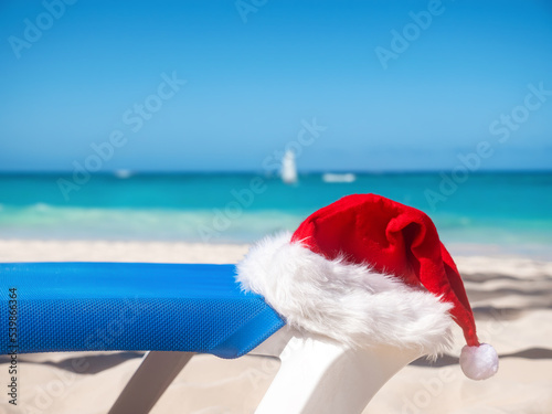 Santa Claus Hat on sandy beach. Tropical New year celebration