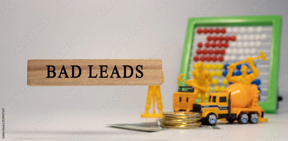 Fototapeta premium Bad Leads written on wooden surface. Economy and markets.