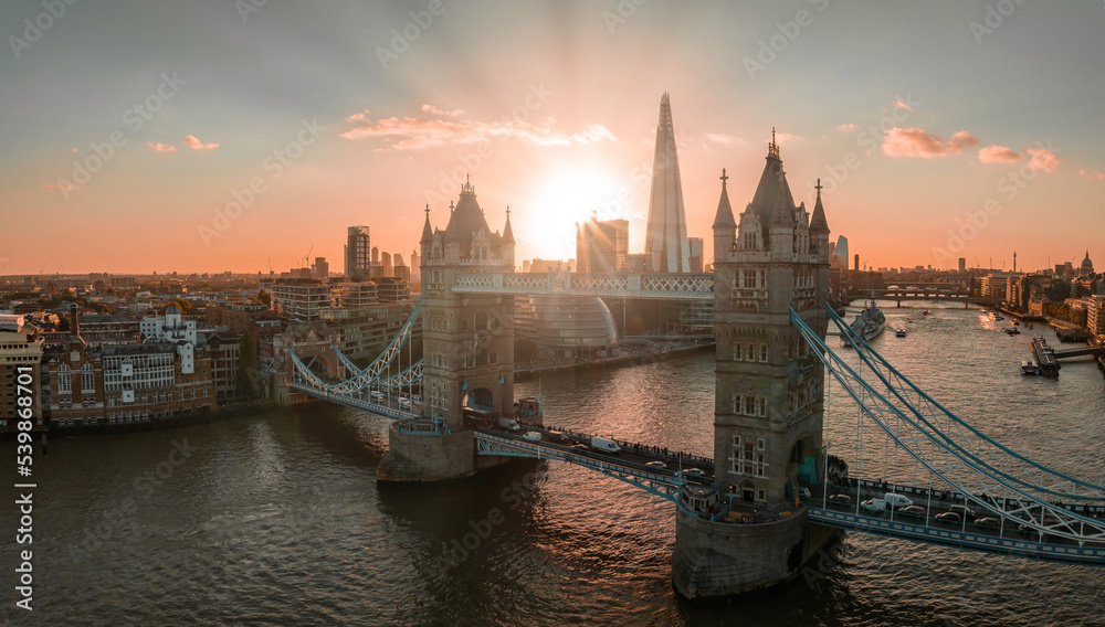 Naklejka premium Aerial view of the London Tower Bridge at sunset. Sunset with beautiful clouds over London - the capital of Britain.