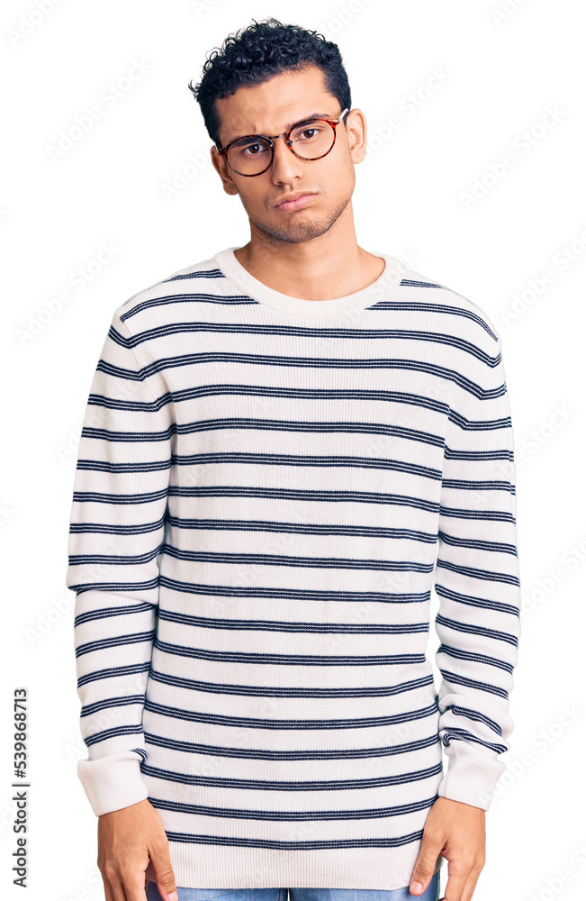 Hispanic handsome young man wearing casual clothes and glasses depressed and worry for distress, crying angry and afraid. sad expression. Hispanic handsome young man wearing casual clothes and glasses depressed and worry for distress, crying angry and afraid. sad expression.