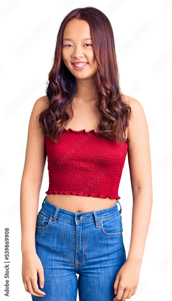 Young beautiful chinese girl wearing casual clothes with a happy and cool smile on face. lucky person. Young beautiful chinese girl wearing casual clothes with a happy and cool smile on face. lucky person.