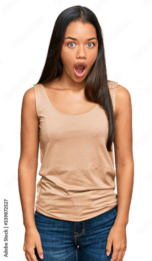 Fototapeta premium Beautiful hispanic woman wearing casual clothes afraid and shocked with surprise expression, fear and excited face.