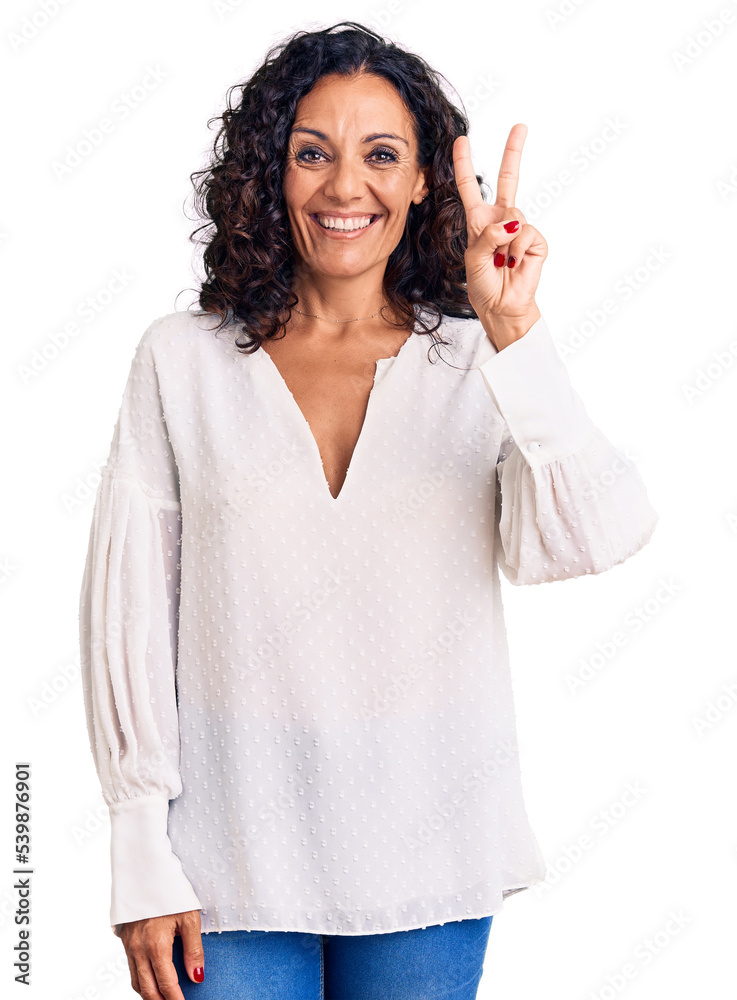 Middle age beautiful woman wearing casual sweater showing and pointing up with fingers number two while smiling confident and happy. Middle age beautiful woman wearing casual sweater showing and pointing up with fingers number two while smiling confident and happy.