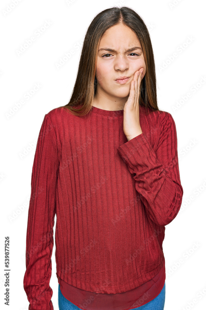 Beautiful brunette little girl wearing casual sweater touching mouth with hand with painful expression because of toothache or dental illness on teeth. dentist Beautiful brunette little girl wearing casual sweater touching mouth with hand with painful expression because of toothache or dental illness on teeth. dentist