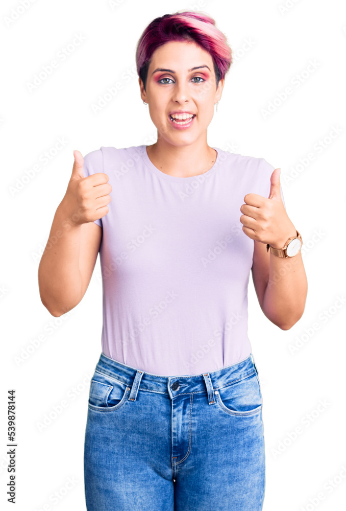 Young beautiful woman with pink hair wearing casual clothes success sign doing positive gesture with hand, thumbs up smiling and happy. cheerful expression and winner gesture. Young beautiful woman with pink hair wearing casual clothes success sign doing positive gesture with hand, thumbs up smiling and happy. cheerful expression and winner gesture.