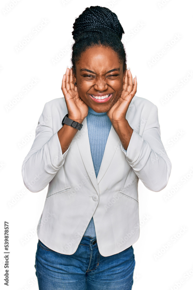 Young african american woman wearing business clothes trying to hear both hands on ear gesture, curious for gossip. hearing problem, deaf Young african american woman wearing business clothes trying to hear both hands on ear gesture, curious for gossip. hearing problem, deaf