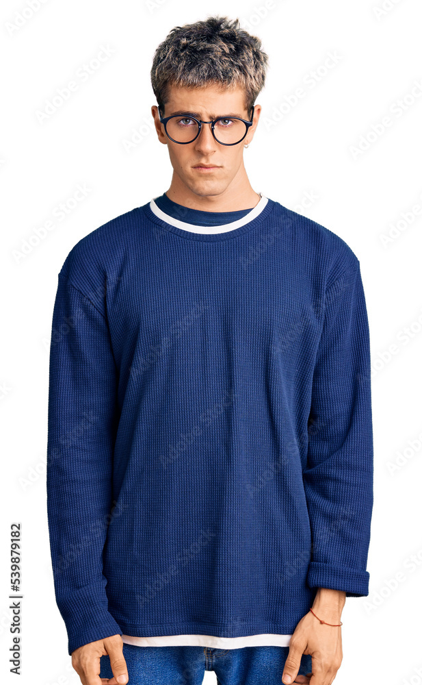Obraz premium Young handsome man wearing casual clothes and glasses skeptic and nervous, frowning upset because of problem. negative person.