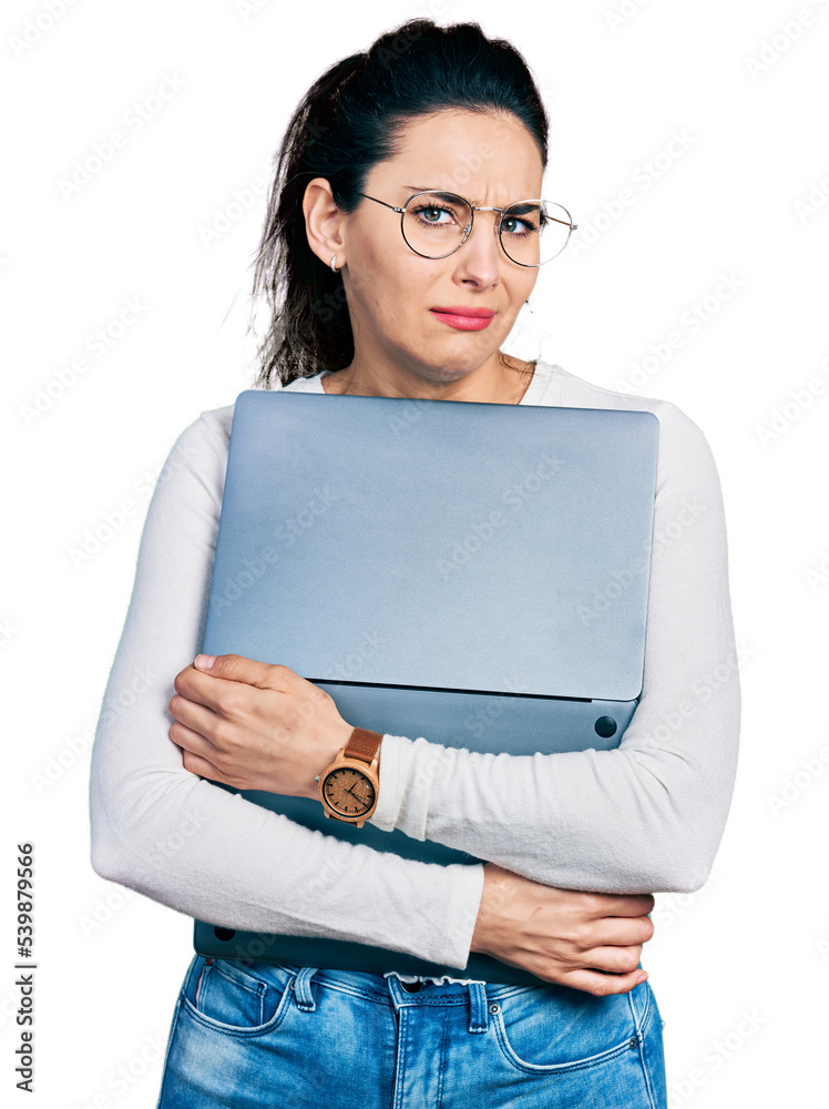 Young hispanic woman working using computer laptop clueless and confused expression. doubt concept. Young hispanic woman working using computer laptop clueless and confused expression. doubt concept.
