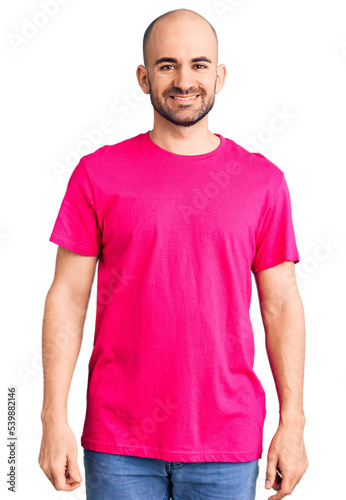 Young handsome man wearing casual t shirt with a happy and cool smile on face. lucky person.