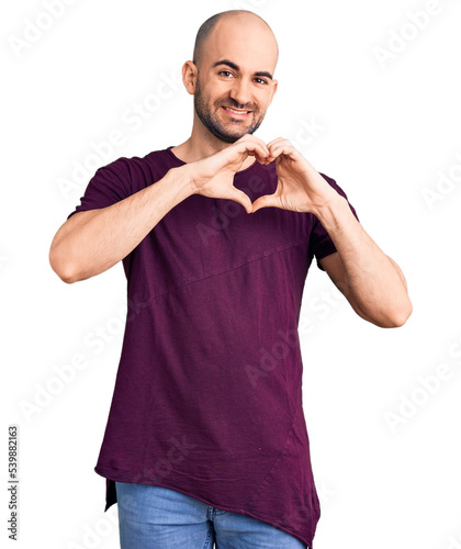 Young handsome man wearing casual t shirt smiling in love showing heart symbol and shape with hands. romantic concept.
