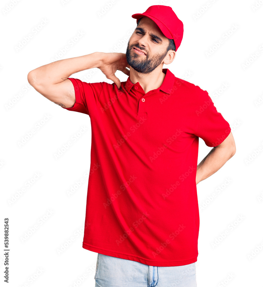 Young handsome man with beard wearing delivery uniform suffering of neck ache injury, touching neck with hand, muscular pain
