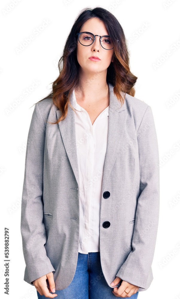 Beautiful young brunette woman wearing business clothes and glasses with serious expression on face. simple and natural looking at the camera. Beautiful young brunette woman wearing business clothes and glasses with serious expression on face. simple and natural looking at the camera.