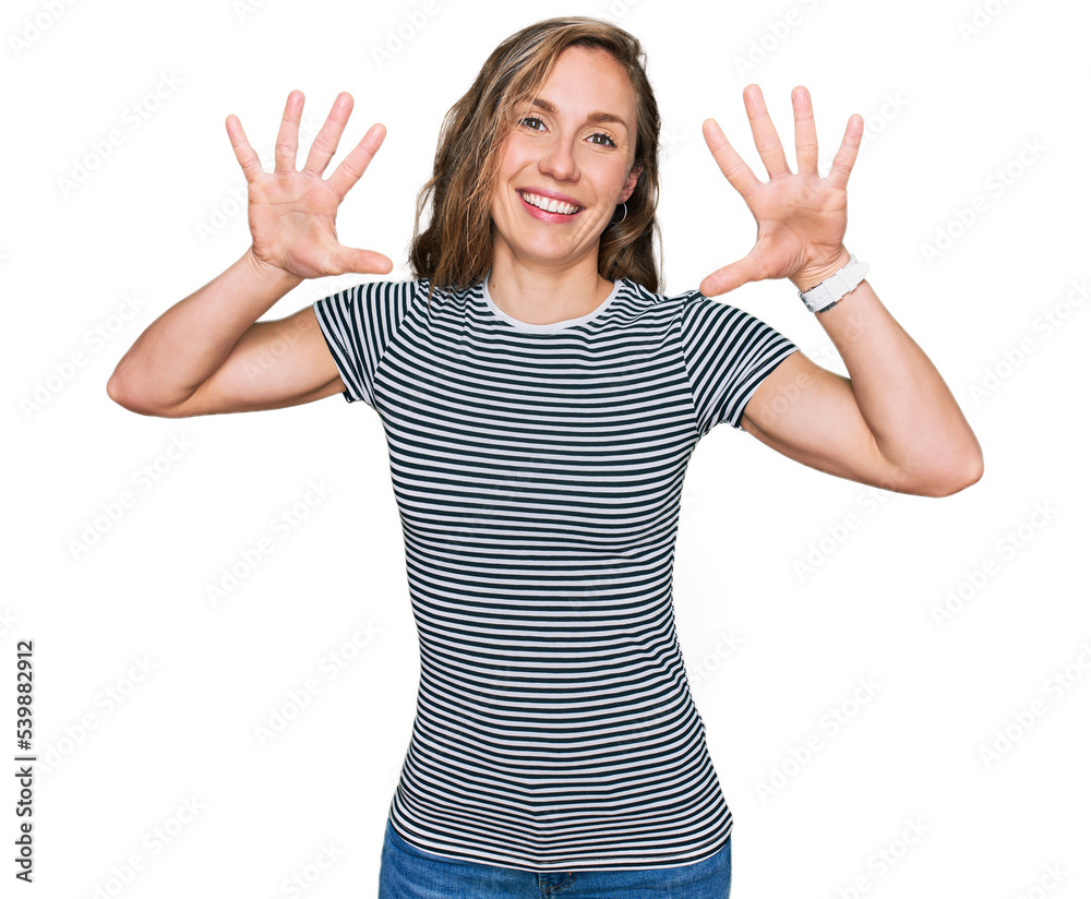 Young blonde woman wearing casual clothes showing and pointing up with fingers number ten while smiling confident and happy. Young blonde woman wearing casual clothes showing and pointing up with fingers number ten while smiling confident and happy.