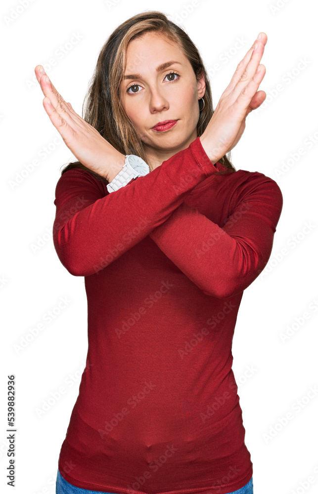 Young blonde woman wearing casual clothes rejection expression crossing arms doing negative sign, angry face
