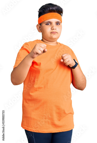 Little boy kid wearing sportswear punching fist to fight, aggressive and angry attack, threat and violence