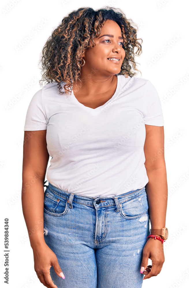 Young african american plus size woman wearing casual clothes looking away to side with smile on face, natural expression. laughing confident. Young african american plus size woman wearing casual clothes looking away to side with smile on face, natural expression. laughing confident.