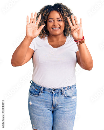 Young african american plus size woman wearing casual clothes showing and pointing up with fingers number nine while smiling confident and happy.