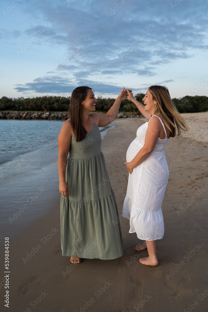lesbian couple dancing on the beach lesbian couple dancing on the beach