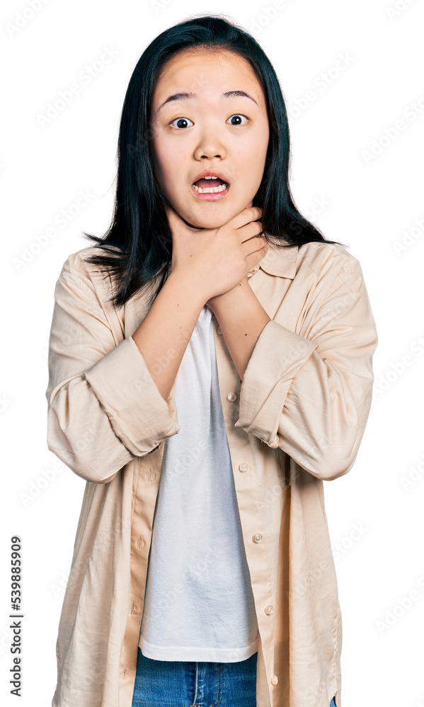 Young chinese woman wearing casual white t shirt and jacket shouting and suffocate because painful strangle. health problem. asphyxiate and suicide concept. Young chinese woman wearing casual white t shirt and jacket shouting and suffocate because painful strangle. health problem. asphyxiate and suicide concept.