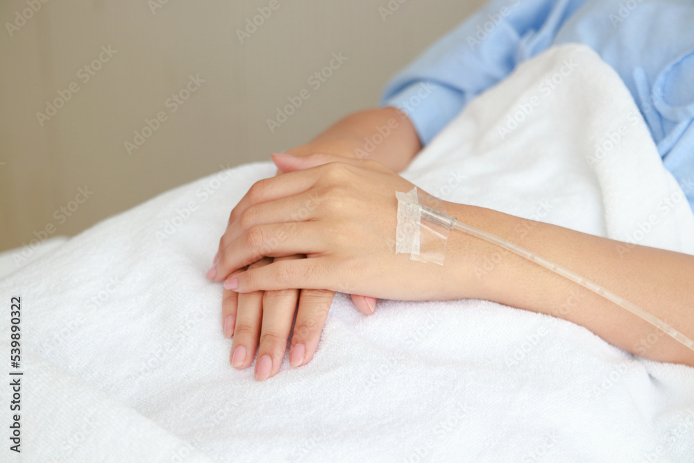 Fototapeta premium Asian female patient lying on bed in patient room Give sodium chloride through a vein. The concept of health insurance. hospital medical services